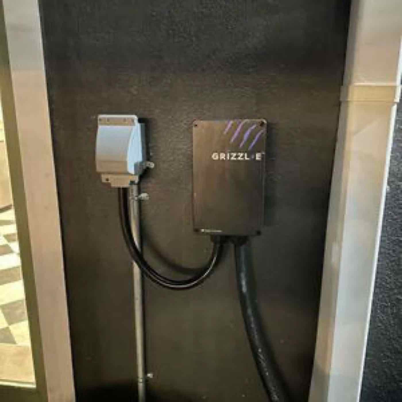 A wall-mounted EV charger in a garage.