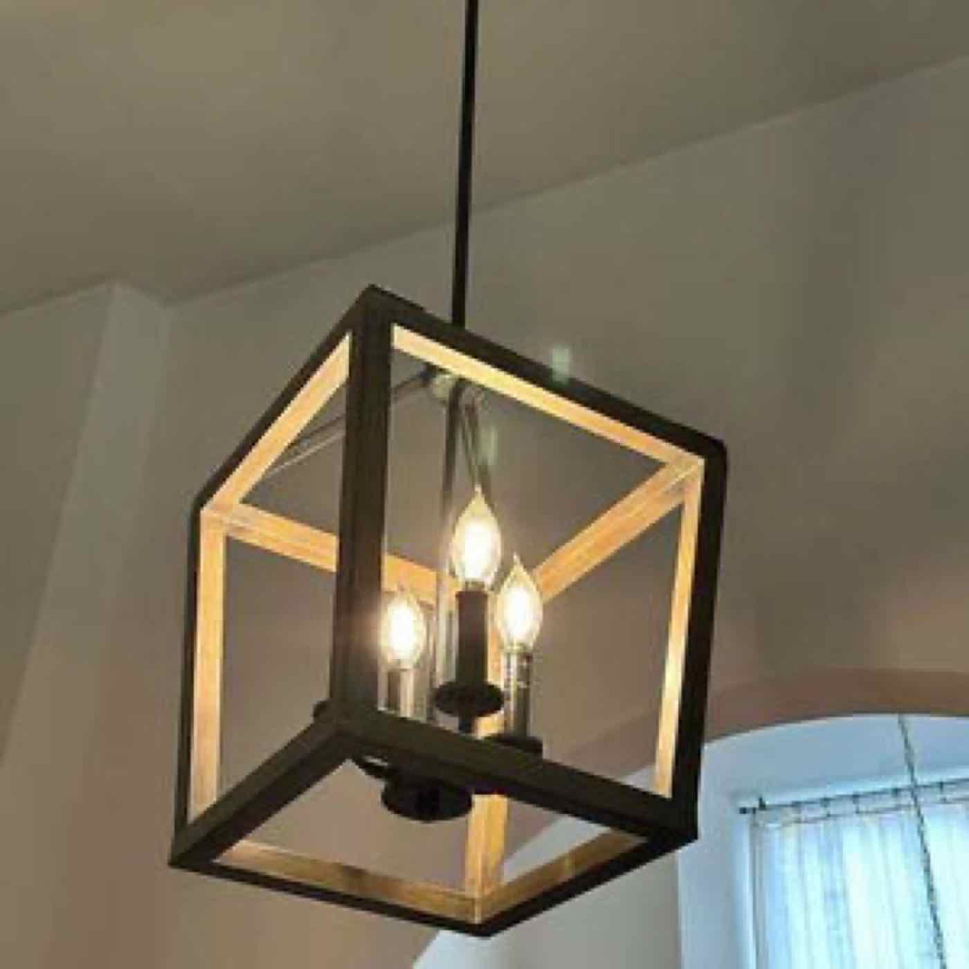 A lantern-style pendant light in a high-ceilinged room.